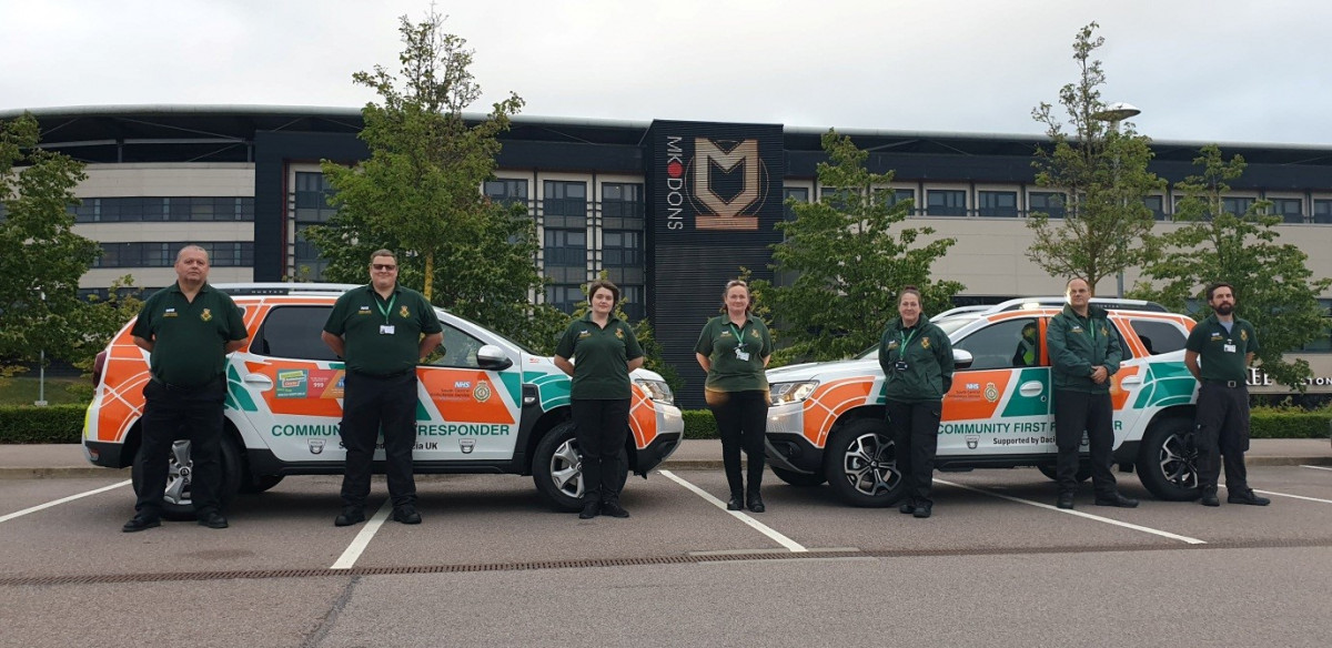 ambulance cars with volunteers outside