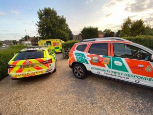 ambulance cars with volunteers outside