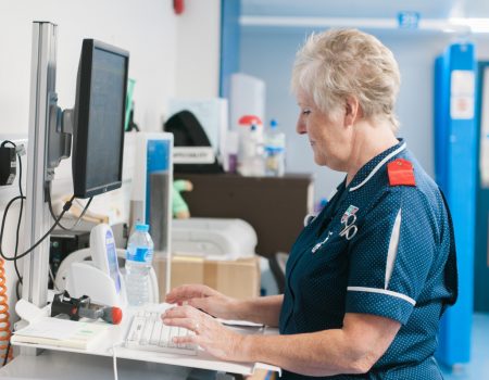 Staff member in ED working on computer