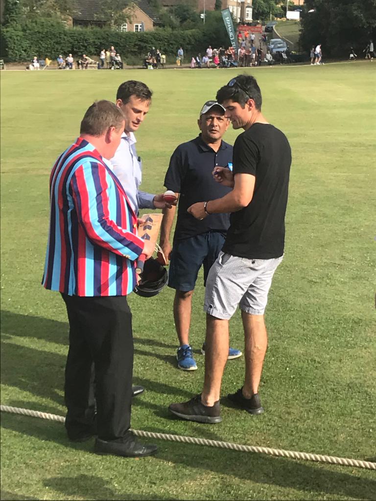 Director of Finance, Matt Gibbons on the cricket pitch with three others