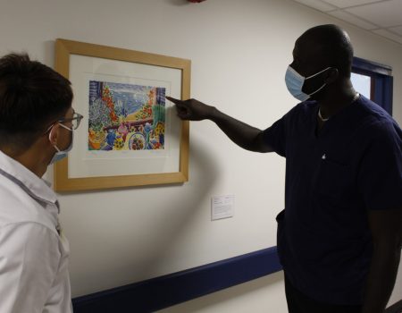 staff enjoying a painting on the wall