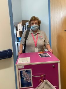 Blossom volunteer , Rose, standing with blossom trolley