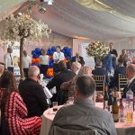 Attendees sitting round table for Cricket Luncheon