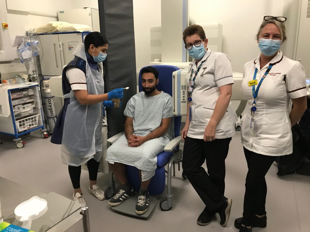 staff with patient using chair