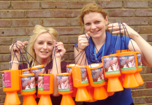 Two women holding collection buckets