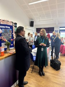 Liz Lees speaking with a Blossom volunteer