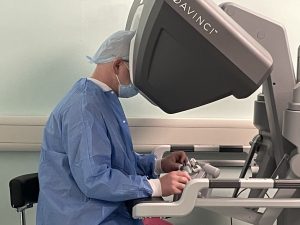 A surgeon using the console during surgery