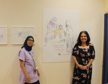karen and staff member with artwork drawn during COVID-19 pandemic
