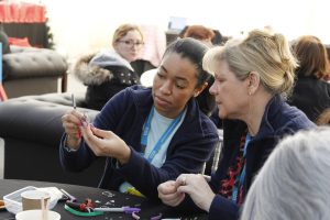 Staff members making key rings