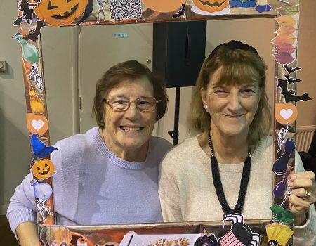 Volunteers with a Halloween picture frame