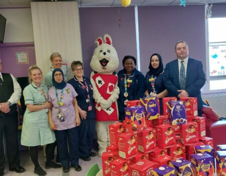 Staff with the Easter bunny and a table of Easter eggs