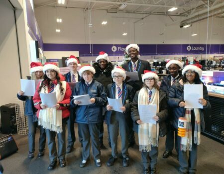 Student choir dressed in Santa hats