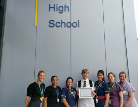 Staff and students outside Putteridge High School holding a certificate