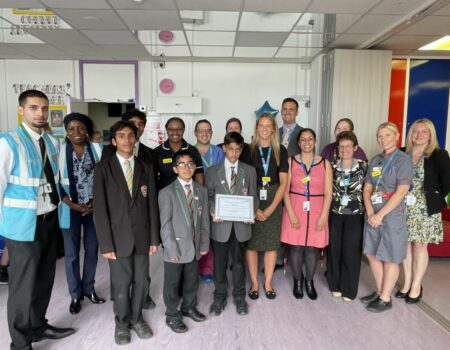 Students and staff with a certificate