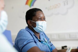 Nurse smiling wearing a face mask