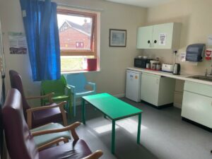 Parents Room showing a table and chairs, microwave and fridge