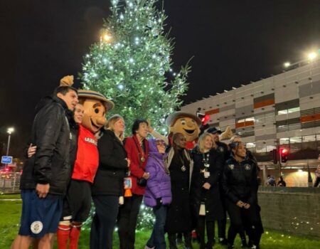 Luton Town FC and hospital staff standing by the Christmas tree