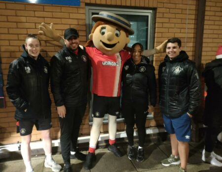 Luton Town FC staff and players with their mascot