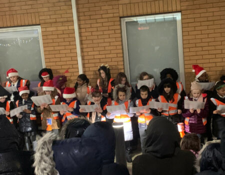 A school choir singing at the Light Up ceremony