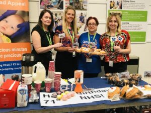 Charity team celebrating with cakes