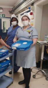 Nurse holding pizza