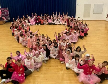 Challney Girls School sitting in a ribbon shape for Breast Cancer awareness