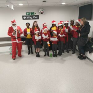 Chantry Childrens Choir in Father Christmas costumes