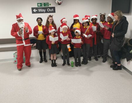 Chantry Childrens Choir in Father Christmas costumes