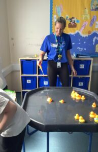 Sabine playing a fairground game with rubber ducks