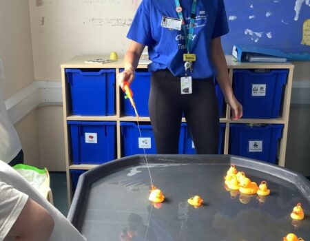 Sabine playing a fairground game with rubber ducks