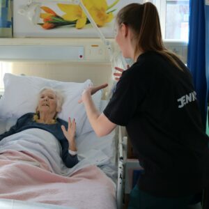 A patient waving her hands alongside Jenny, Dance for Health Practitioner 
