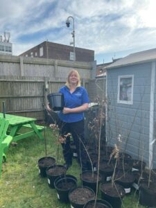 Charmaine with a tree for Maternity Courtyard Garden