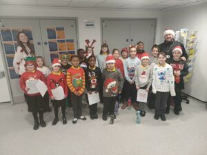 The Meads Childrens choir in Christmas jumpers and hats