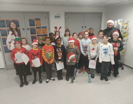 The Meads Childrens choir in Christmas jumpers and hats