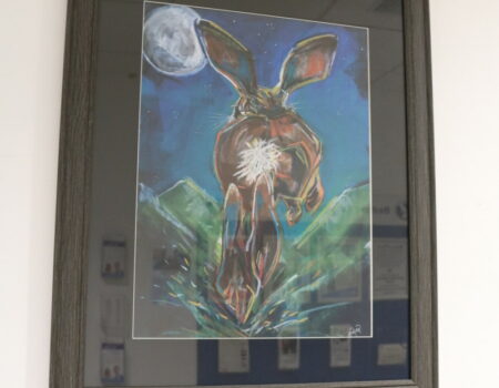 Artwork of a hare jumping through fields in the moonlight