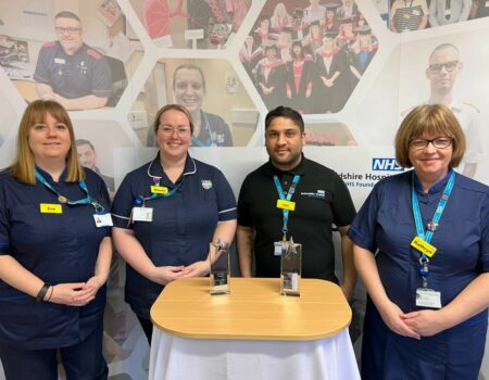 Some of the apprenticeship team together with trophies