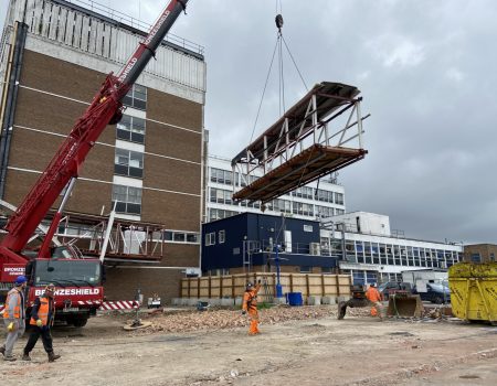 Bridge being carried by crane