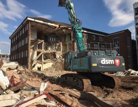 Machine demolishing building