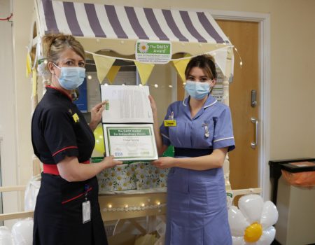 Chloe receiving her award from Liz