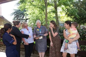 Photo of staff with Maternity Compliments Book
