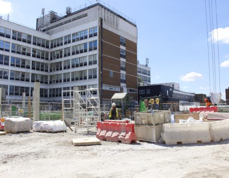 Groundwork being done with worker next to equipment