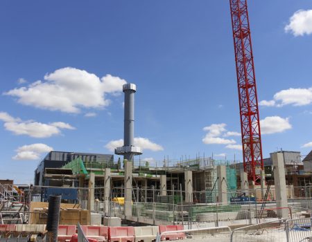 Crane tower in the background of redevelopment upgrade with building work taking place