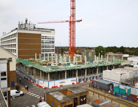 Building site with red crane in the middle