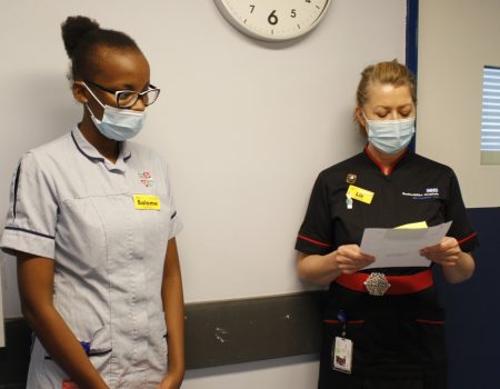 Chief Nurse Liz Lees is presenting and Salome Keriti stands on the left