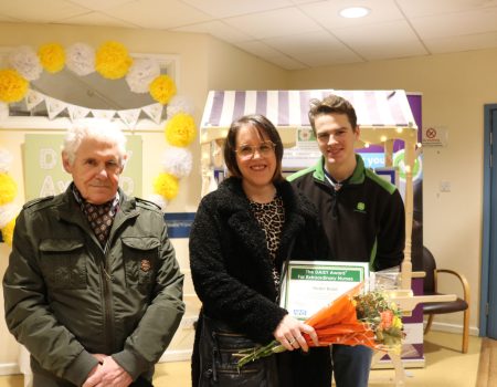 Helen Braid with her family members smile at the camer