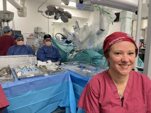 Katherine in theatre with her team and the robot