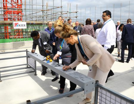 Liz Lees signing the steel beam