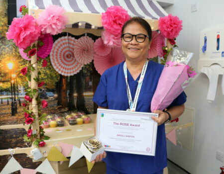 Ali smiling in front of the ROSE cart