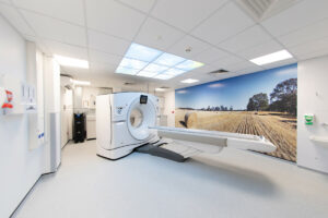 Bedford Hospital CT scanner with photo of fields on the side wall and sky panels above the scanner