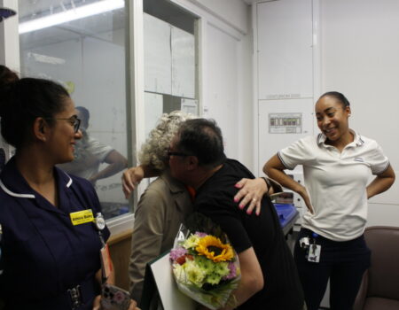 James hugging Sandra with his flowers